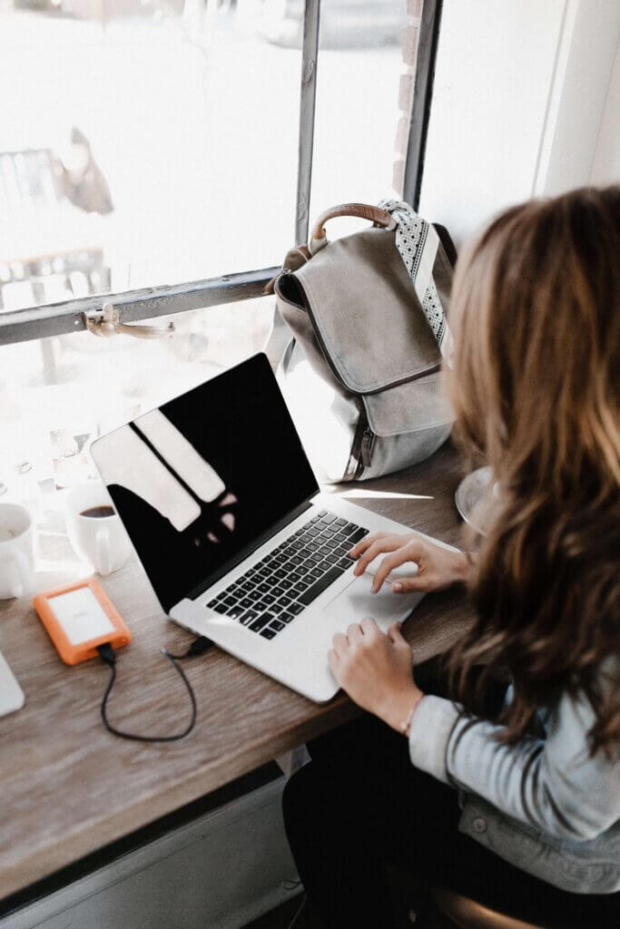 long haired working near a window - Embracing a Growth Mindset