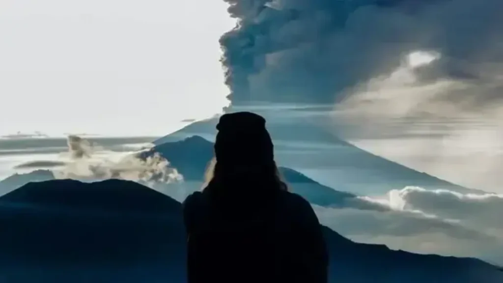 Woman-looking-at-a-smoking-volcano